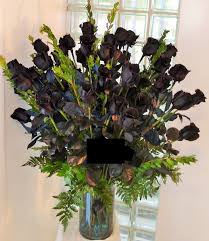 48 long stem black roses arranged in a