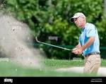 Corey Pavin plays a bunker shot on the 10th hole at Fontainebleau ...