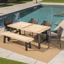 Outdoor elegance offers everything you need to enjoy eating and socialising outdoors, with our extensive range of outdoor dining tables, chairs, and benches to suit every property. Noble House Coleman 6 Piece Wood And Wicker Outdoor Dining Set With Stacking Chairs And Bench 24297 The Home Depot
