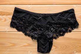 Feminine Satin Panties With Lace In Black On The Wooden Floor Closeup Stock  Photo, Picture and Royalty Free Image. Image 66814094.