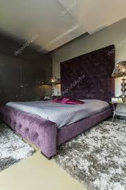 big bed with violet pillows stock photo