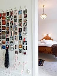 We love the way they printed their photos in black and white and hung them from the mesh using miniature crafting clothespins. 17 Totally Untraditional Unique Ways To Hang Pictures On Your Wall Postcard Wall Postcard Display Hanging Pictures