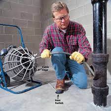to unclog a pipes using a drain auger