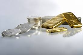 gold and silver coins showing weakness
