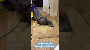 the proper way to vacuum a bath mat