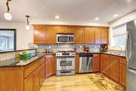 maple kitchen cabinets with steel