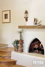 Lit Fireplace With Wooden Stairs At