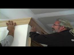 install crown molding along the ceiling