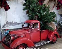 He measured the distance between the tires and used this distance to hammer each on approximately 1 foot into the ground. Red Metal Truck With Christmas Tree Etsy