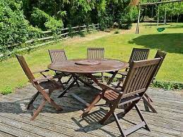 round wooden garden table and 6 chairs