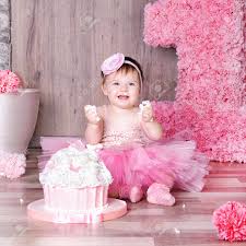 1 Year Baby Girl In Pink Dress With Her First Birthday Cake Stock