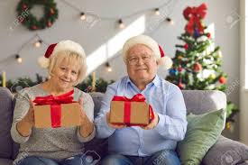 The twins were excited about decorating the christmas tree. Portrait Of Happy Grandparents In Santa Hats Sitting On Couch At Home Holding Christmas Presents For Grandchildren Video Call Webcam Picture Of Grandma And Grandma Giving Gift Boxes To Grandkids Banque D Images