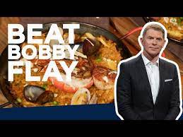 bobby flay makes seafood paella beat