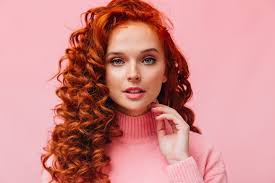 curly redhead woman with blue eyes