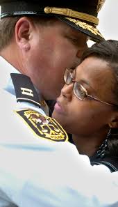 Captain W.D. Jagoe consoles Latoya Bryant, wife of slain DeKalb Police Officer Ricky Bryant Jr. after the ceremony. RENEE&#39; HANNANS HENRY/AJC - slideshow_537353_OFFICERSKILLED.0509_3_1