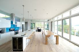 Planning for the perfect kitchen island is as much about getting the dimensions right as it is about the extra cabinet space and additional perks it brings. Like The Configuration Of The Island And Elongated Table Kitchen With Long Island Modern Kitchen Design Long Kitchen