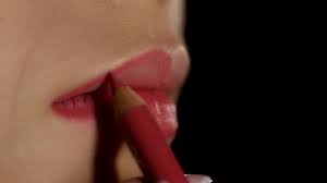makeup artist applying lip liner to
