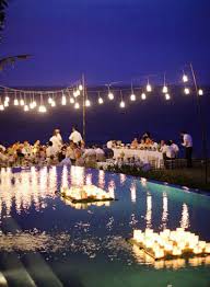 5 Beautiful And Budget Friendly Decorating Ideas For Summer Parties Pool Wedding Wedding Lights Floating Candles
