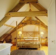 an attic room with a rustic wood beam