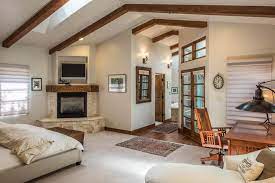 master bedroom with ceiling beams and