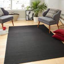 black indoor solid area rug in the rugs