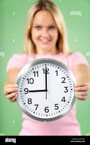 Woman Holding Clock Showing 9 O'Clock Stock Photo - Alamy