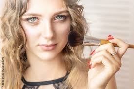 beautiful young woman holding makeup