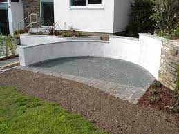 Curved Rendered Wall With Stone Coping