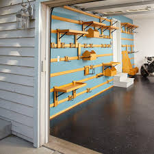 Garages storage garage organization organization tips and hacks how to go vertical keep brooms, mops and dustpans off the floor and out of the way by crafting a handy organizer out of scrap wood and pipe straps. Small Garage Storage Ideas You Can Diy Family Handyman