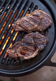 grilled ribeye steaks cooked in a fire