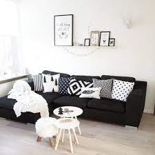 black sofa with white and grey cushions