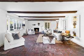 living room with brick floors