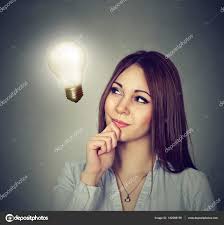Happy Woman Thinking Looking Up At Bright Light Bulb Stock