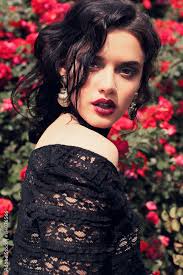 black lace dress posing beside roses