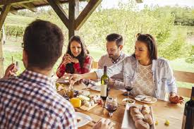 A snack is a small portion of food eaten between meals. Friends Socializing At Outdoor Table With Red Wine And Cold Snacks Bottle Adults Stock Photo 177766470