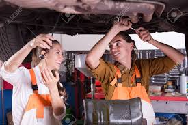 Handsome Mechanic And Beautiful Female Assistant Working At Auto