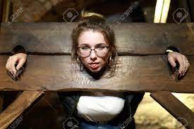 Portrait Of Girl In A Wooden Pillory Stock Photo, Picture and Royalty Free  Image. Image 112465163.