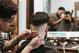 trendy barber cutting man s hair at
