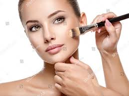 makeup artist applying liquid tonal