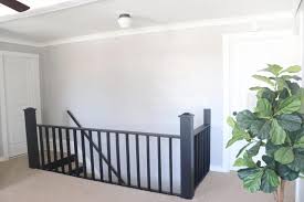 To do this, sand your banister lightly and use painter's tape to protect your walls. Modern Painted Staircase Remodel