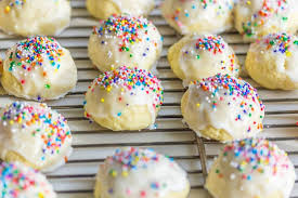 Italian anise cookies stand out on the cookie tray because of its glazed top and colorful sprinkles. Italian Wedding Cookies