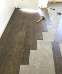 Shows installers creating a perfect seam on a vinyl floor. Vinyl Plank Flooring Prep Installation Centsational Style Waterproof Vinyl Plank Flooring Vinyl Plank Flooring Vinyl Plank