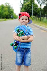 cute baby boy in a red cap skates on a