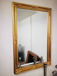 large wooden frame ornate wall mirror