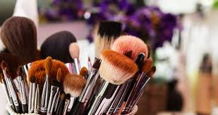 makeup artist cleans his makeup brushes