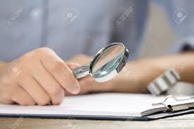 Woman Using Magnifying Glass At Table, Closeup Stock Photo, Picture And  Royalty Free Image. Image 137858384.