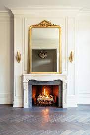 Gold Ornate Mirror On French Fireplace