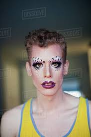 portrait of a young man in drag makeup