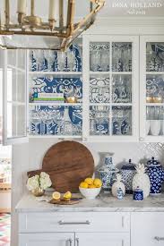 Try pairing them with sleek, silver finishes. Designer Spotlight Dina Holland Design Matters Kitchen Wallpaper Wallpaper Shelves Glass Kitchen Cabinets