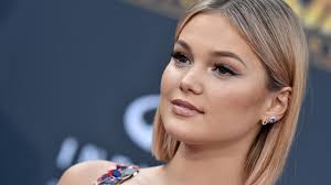 The hunt is on as a government assassin comes out of retirement to track down a killer extraterrestrial murdering the former members of his team in this science fiction thriller set in an alternate future america. Olivia Holt Talks Freeform S Turkey Drop And New Single People Com